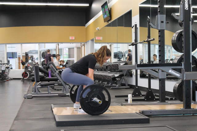 Woman doing a dead lift in gym