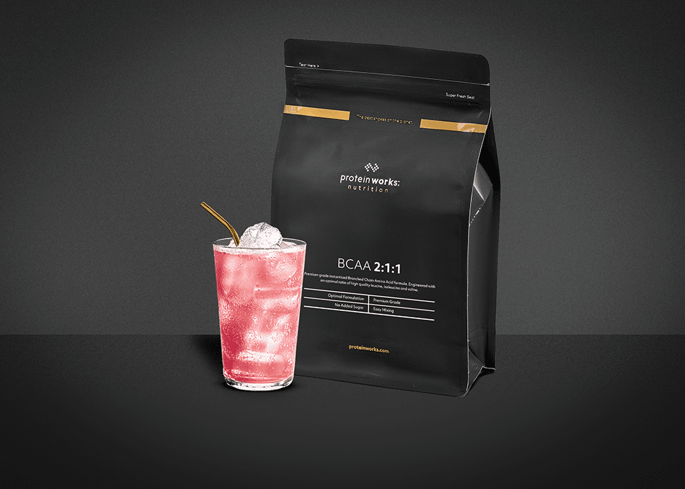 BCAAs in a glass against a dark background